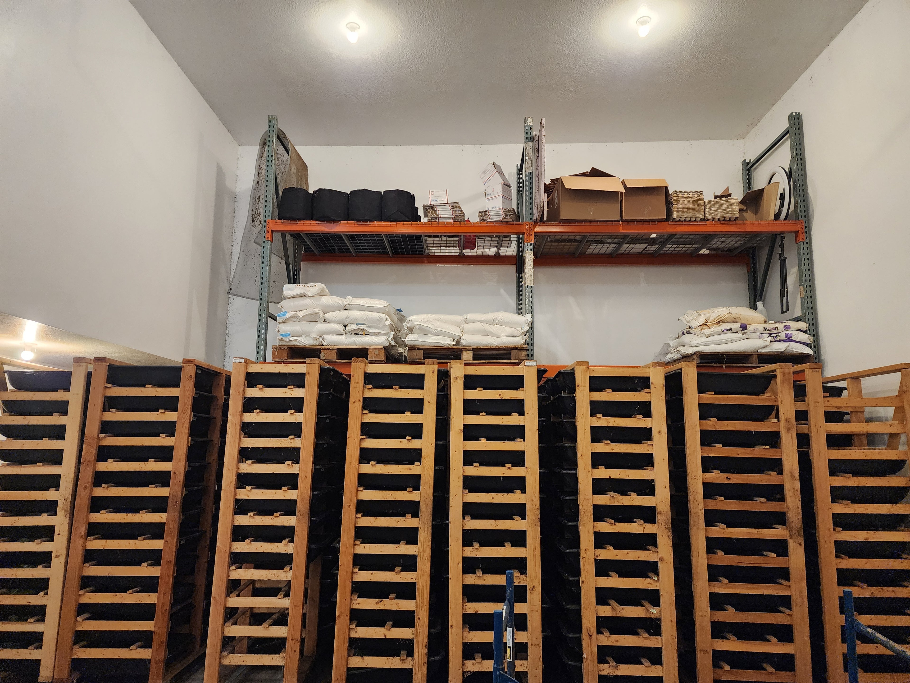 Commercial Worm Farm with hundreds of breeding trays and feed storage